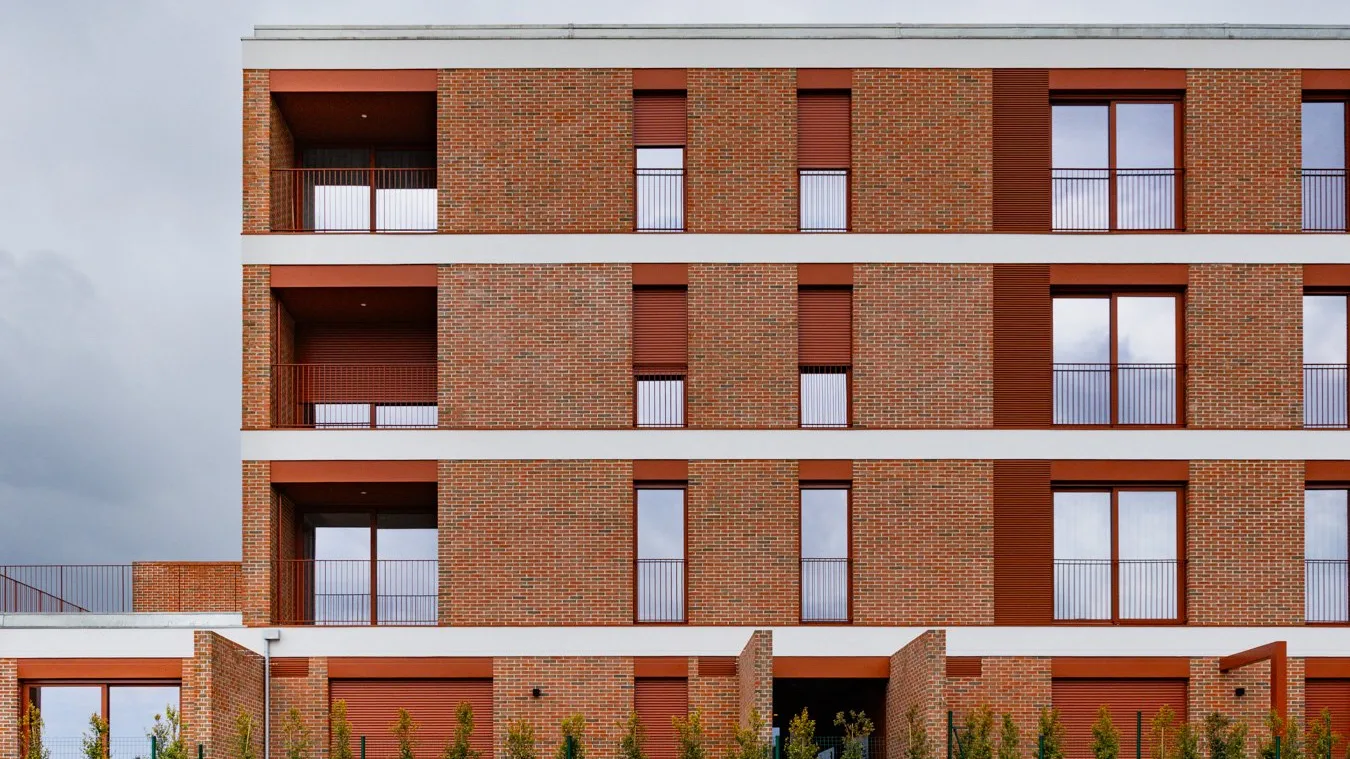 Edifício de habitação com fachada em tijolo vermelho